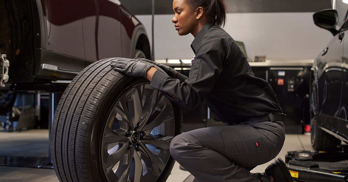 Mazda tire service technician working on a tire