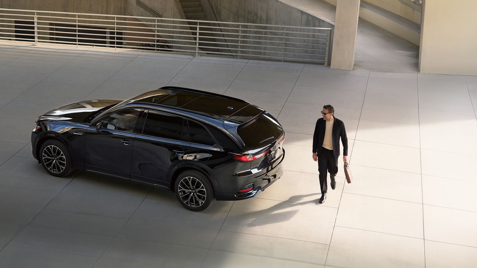 Man walking near a parked 2026 Mazda CX-70