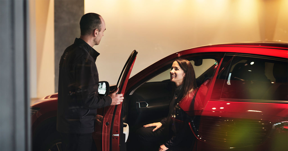 Mazda Loyalty Program customer stepping into a vehicle in the showroom