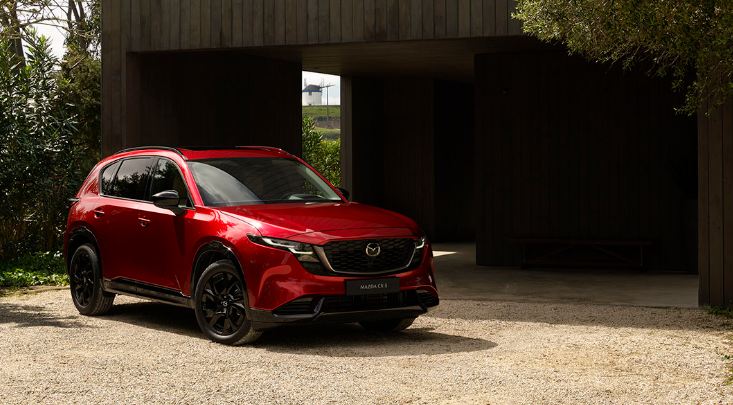 Red Mazda CX-5 SUV parked outside a modern home near Middletown Mazda in Middletown.